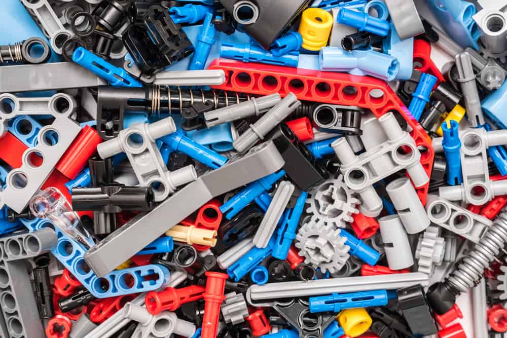 This is a close look at a  pile of lego technic pieces.