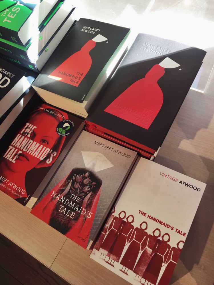 This is a close look at the various covers of The Handmaid's Tale on display at a bookstore.
