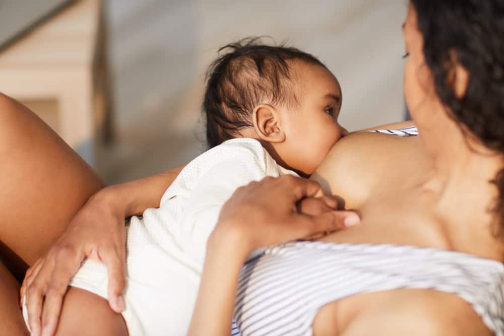 This is a close look at a mother breastfeeding her baby.