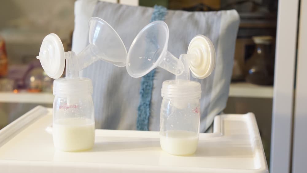 This is a close look at a set of breastpumps with milk inside.