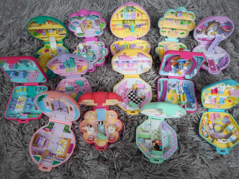 This is a close look at a collection of various colorful Polly Pockets.