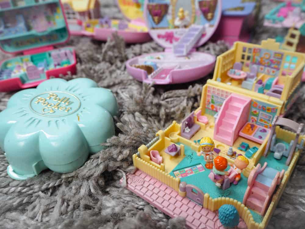 This is a close look at a collection of various colorful Polly Pockets.