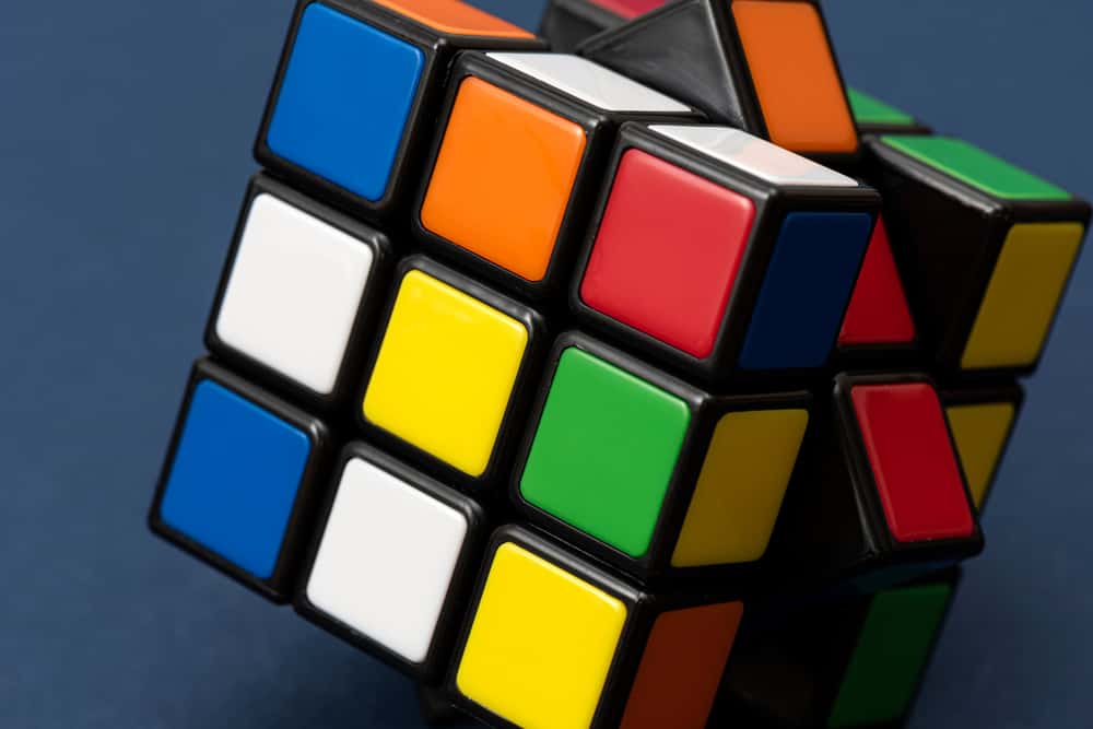 This is a close look at a Rubik's puzzle toy cube with colorful blocks.