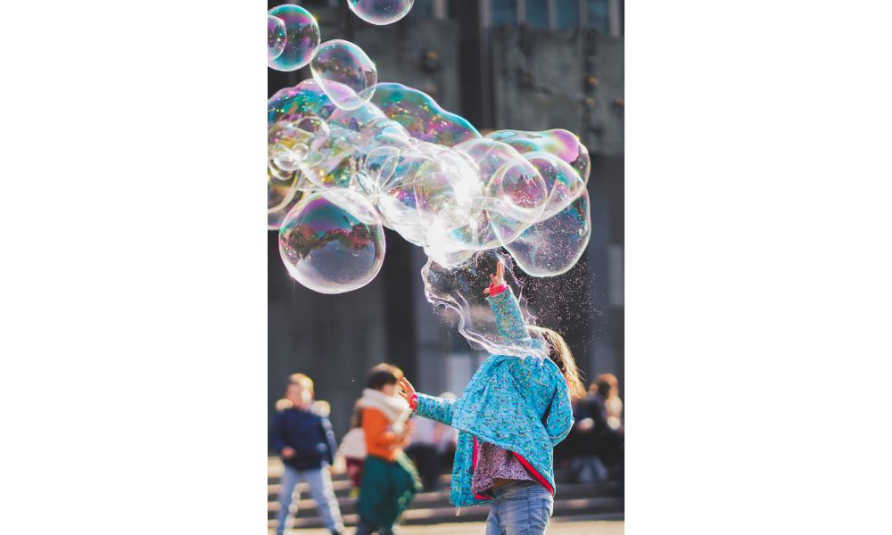 32 Fun Ways to Keep Your 1-Year-Old Entertained Outdoors 3 Playing Bubbles