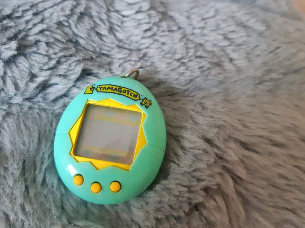 Green Tamagotchi on fur background.