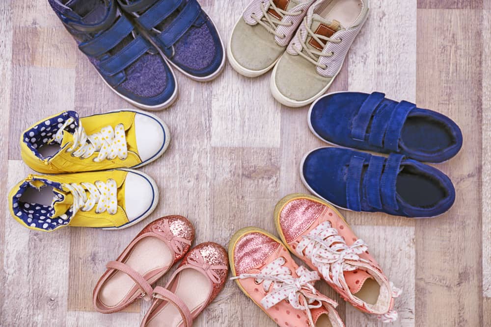 9 Popular Types of Shoes for Kids 1 Various colorful shoes for kids on the floor.