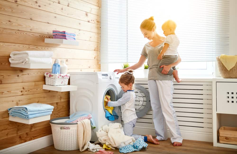 25 Best Indoor Activities for Kids 1 A mother doing the laundry together with her kids. Indoor activities for kids.