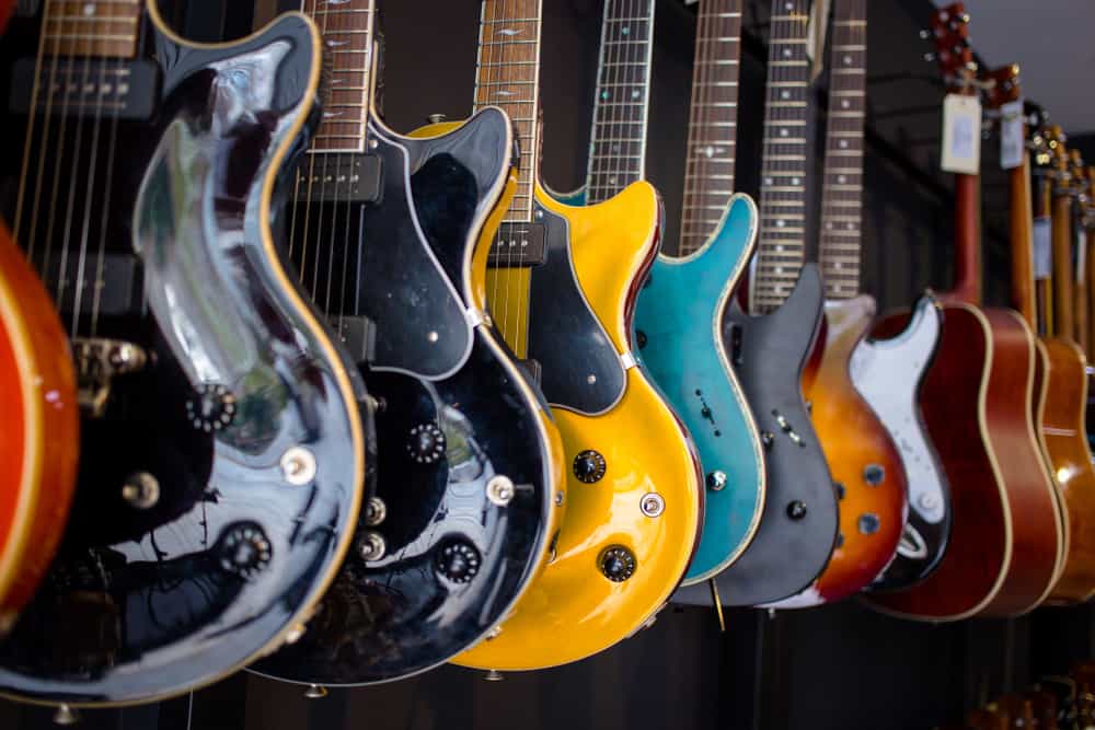 13 Popular Types of Guitars 1 A look at various types of guitars on display at a store.