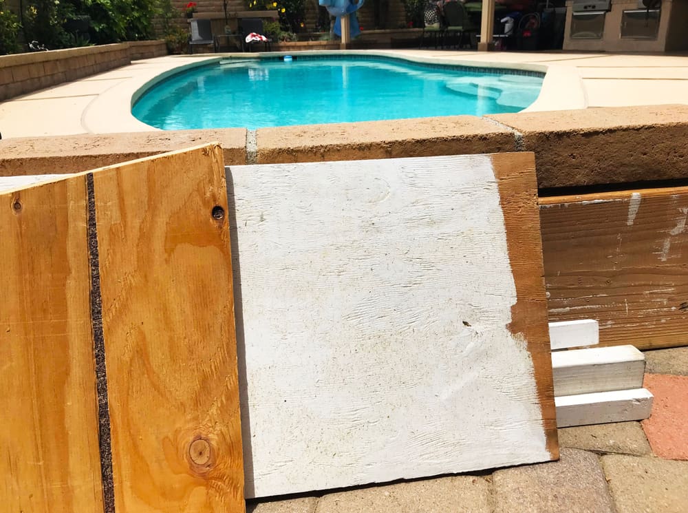A couple of scrap boards placed beside the pool.