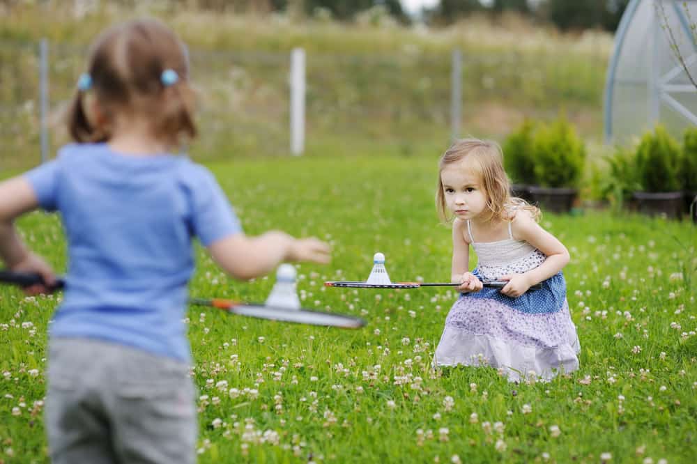 Two girls playing badminton.
