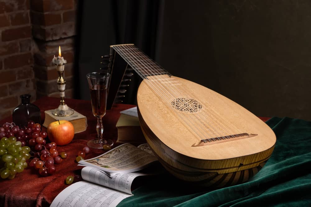 This is a Renaissance style lute on a table with grapes.