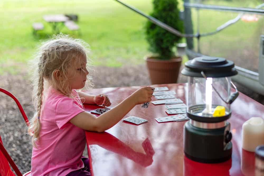 A girl playing a solitaire card game.