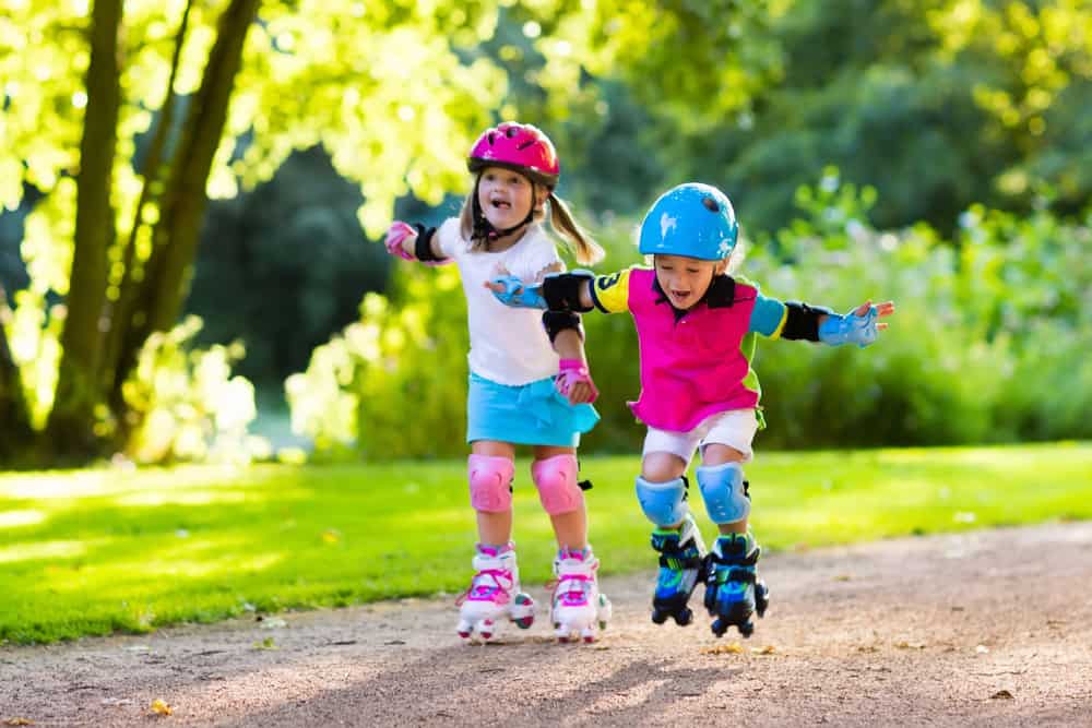 A couple of girls roller skating.