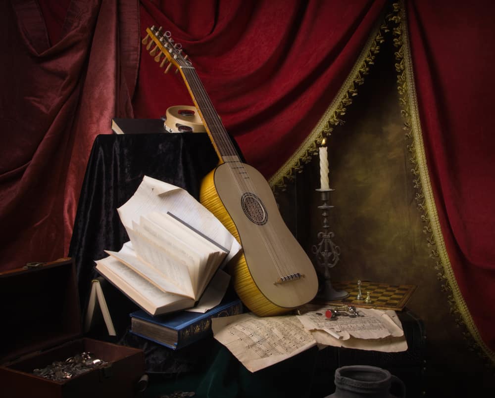 A Renaissance style guitar with music sheets.