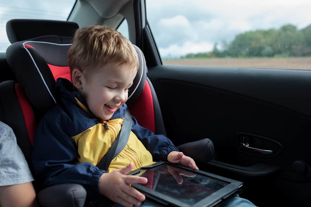 Kid reading a joke book in his tablet.