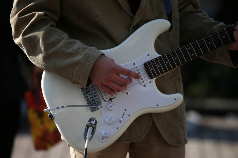A close look at an electric guitar being played.