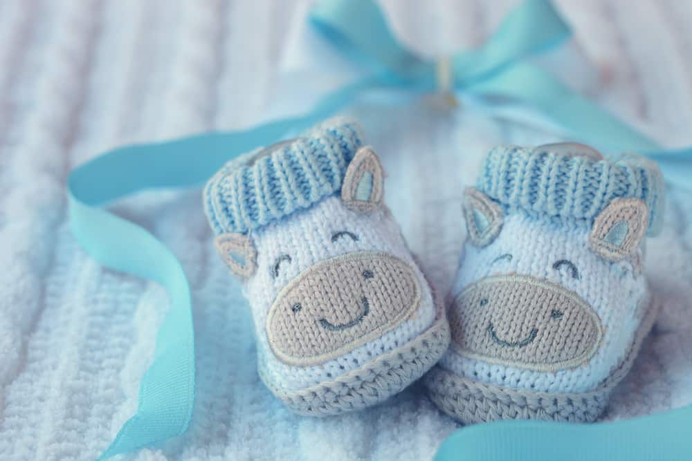 A pair of blue knitted baby shoes.