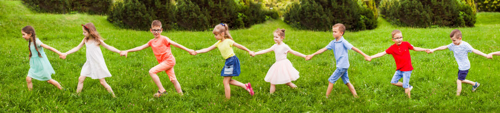 A row of kids playing follow the leader.