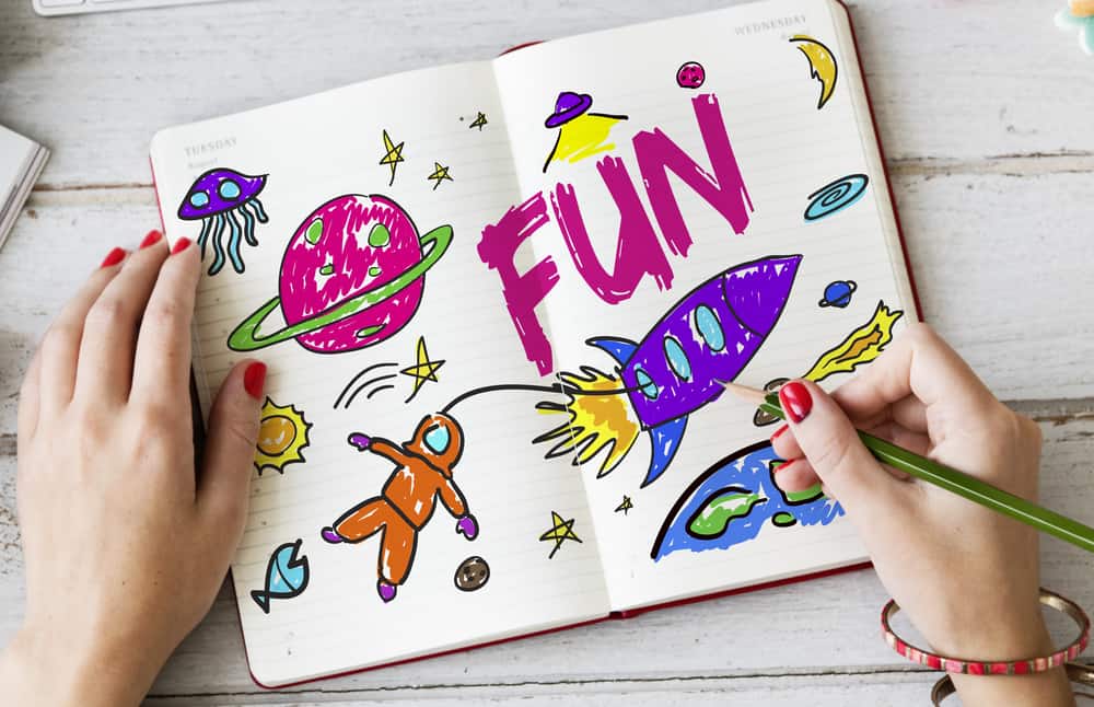 A close look at a colorful drawing of space in a journal.