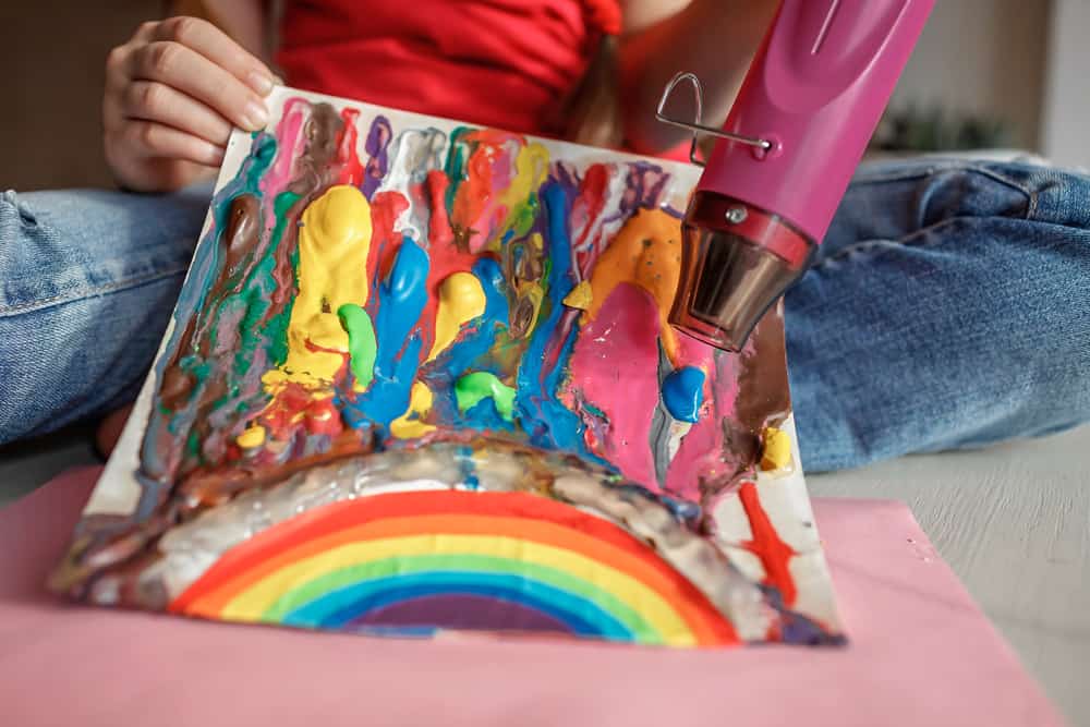 A close look at a girl's melted crayon artwork.
