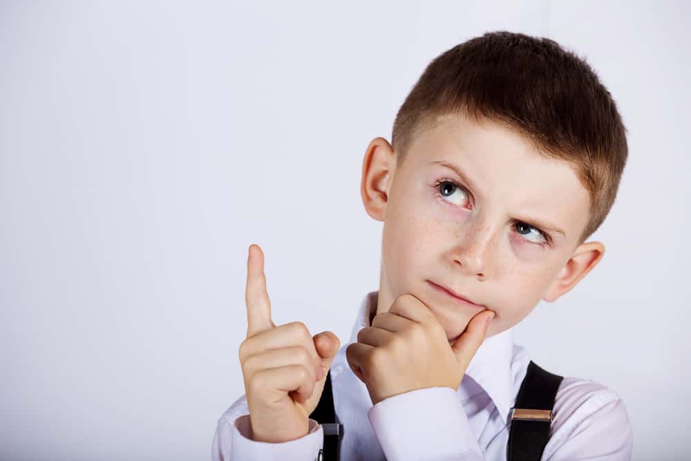 250 Best Would You Rather Questions for Kids 3 A close look at a boy thinking of ideas.