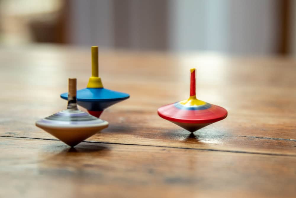 32 Cool Spinning Toys for Kids 3 Colorful wooden spinning tops.