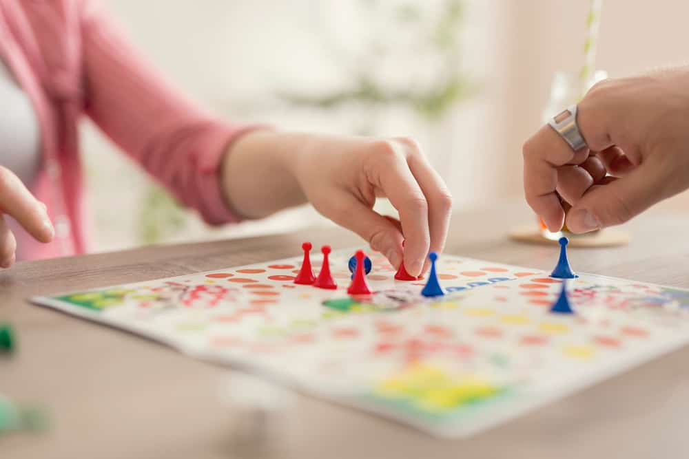 A couple playing a board game.