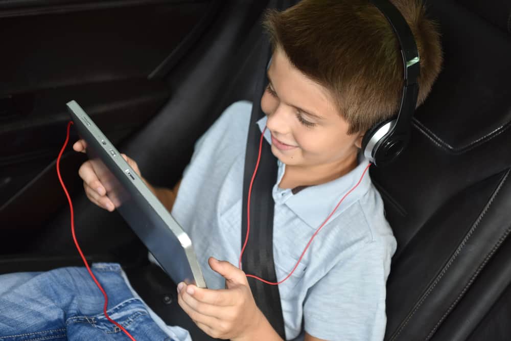 A kid watching a movie on his laptop.