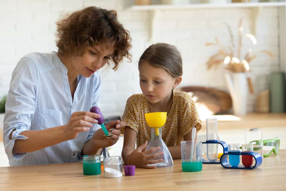 A mother and daughter doing a science experiment together.