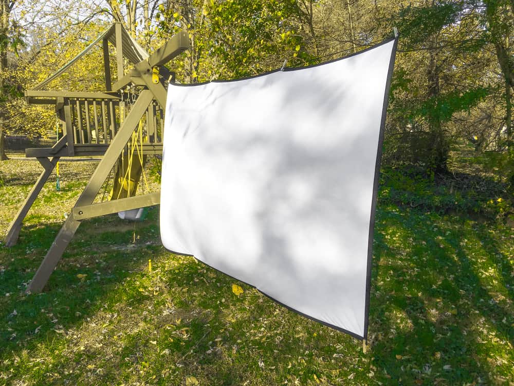 A projector screen setup in the backyard.