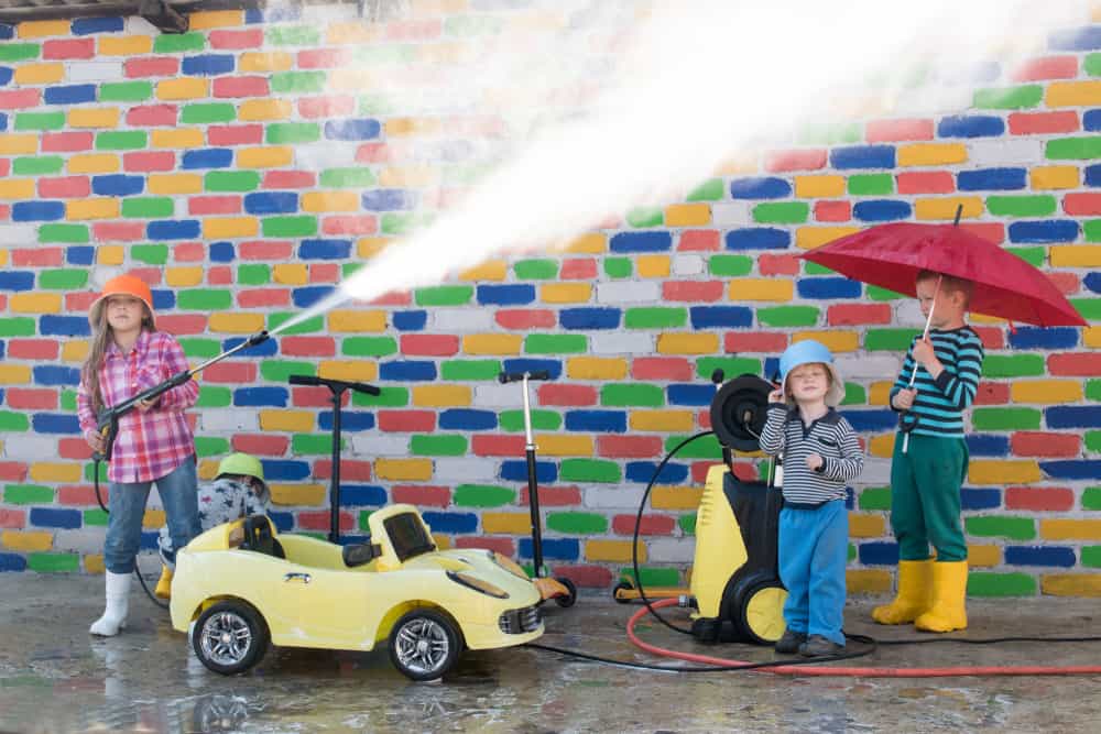 Children playing with carwash equipment and toy cars.