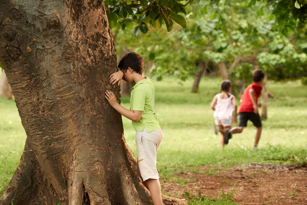A group of friends playing hide and seek.