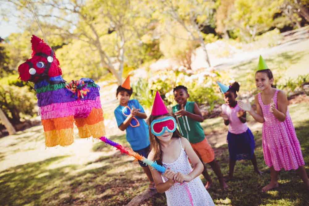 A group of kids at a piñata party.