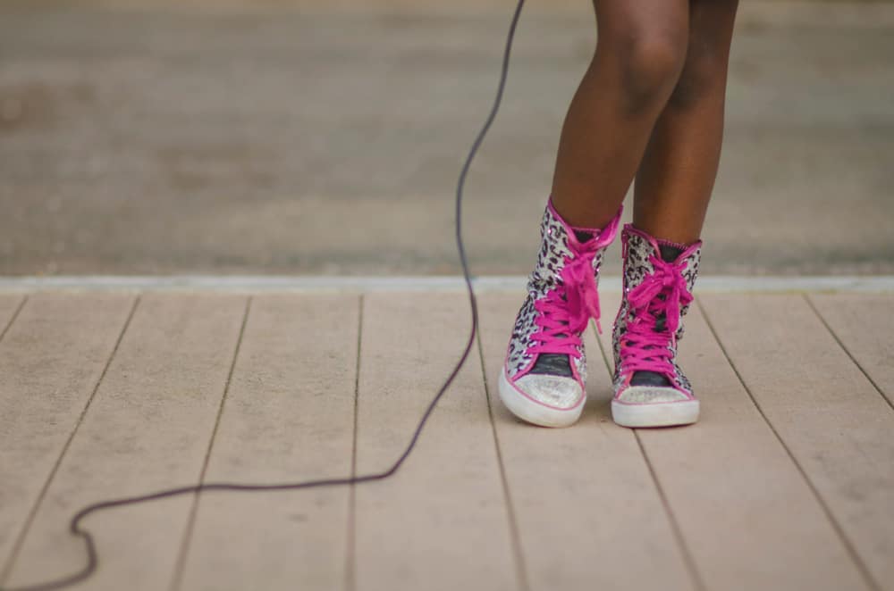A close look at a girl wearing a pair of high tops.