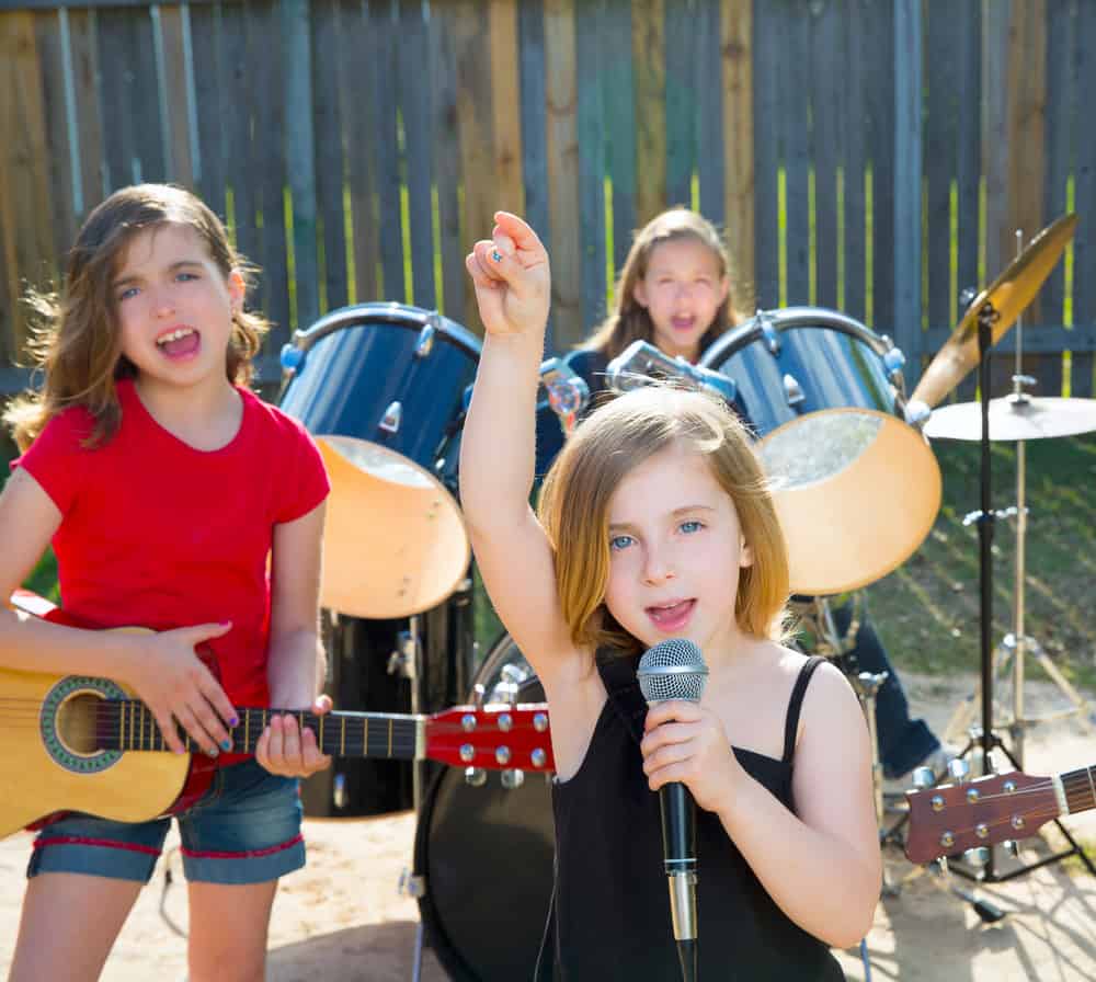 Three girls performing in a band.