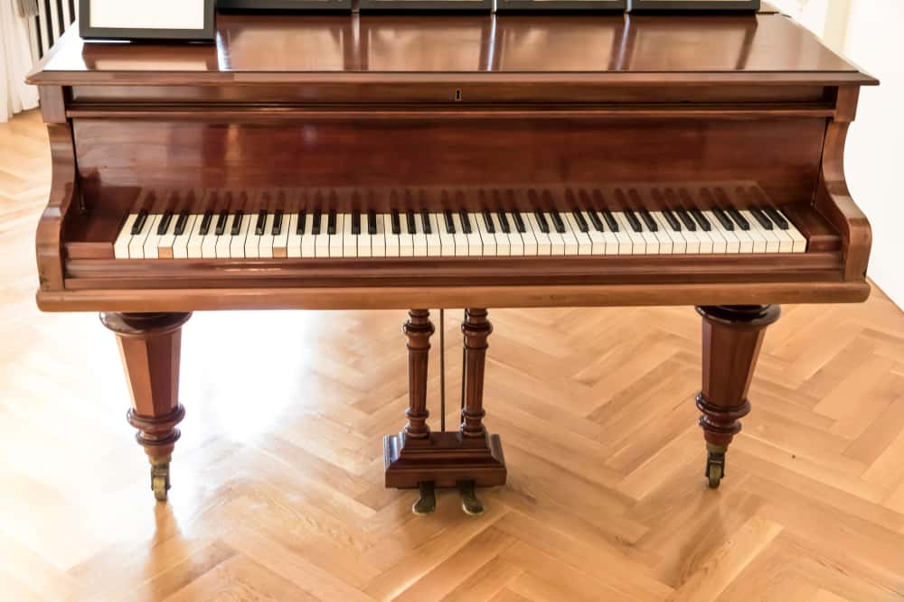 11 Popular Types of Pianos 8 A close look at a wooden ballroom grand piano.