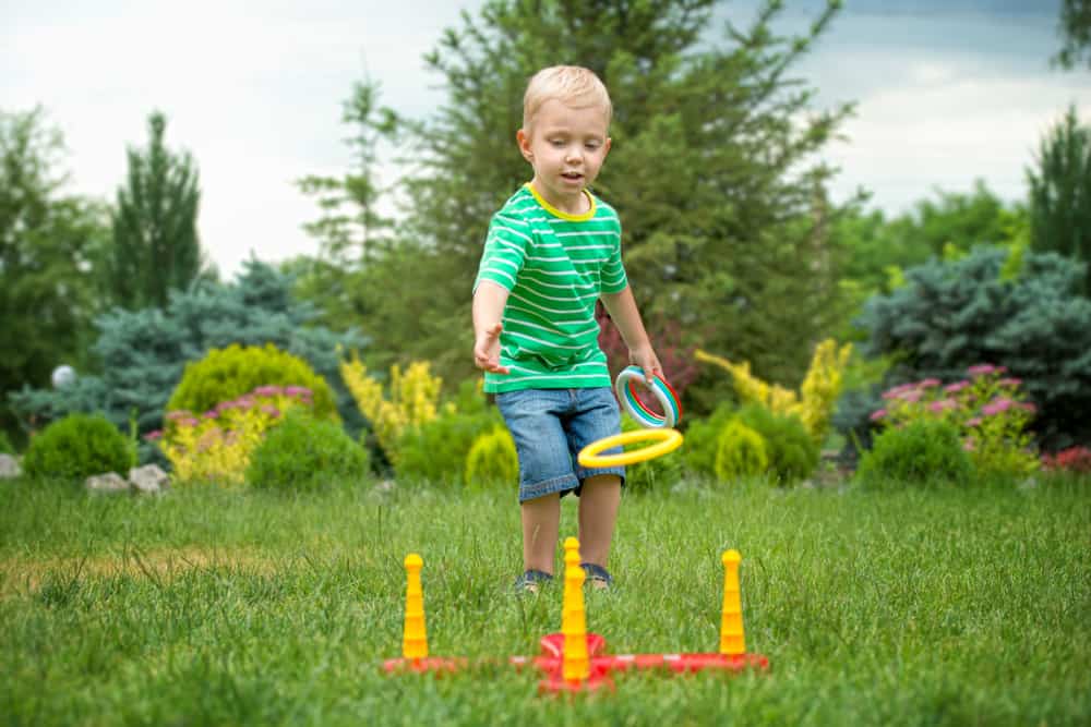 A boy playing ring toss.