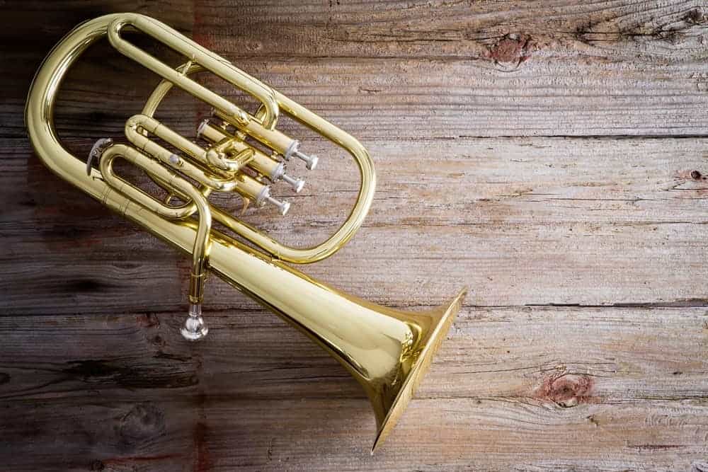 Baritone horn on wooden background.