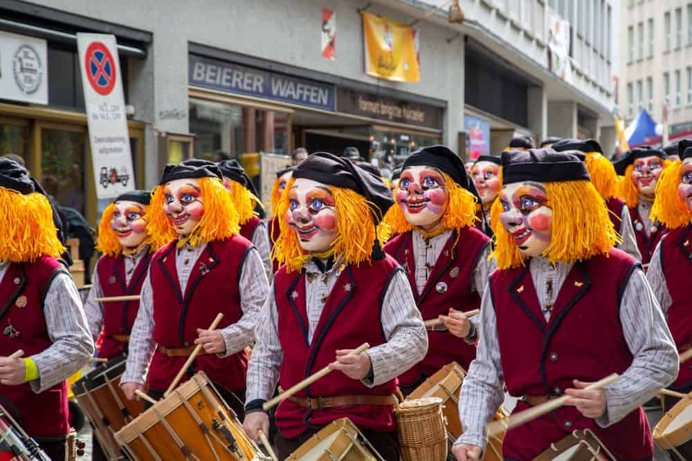 Men playing basler drums during a festival.