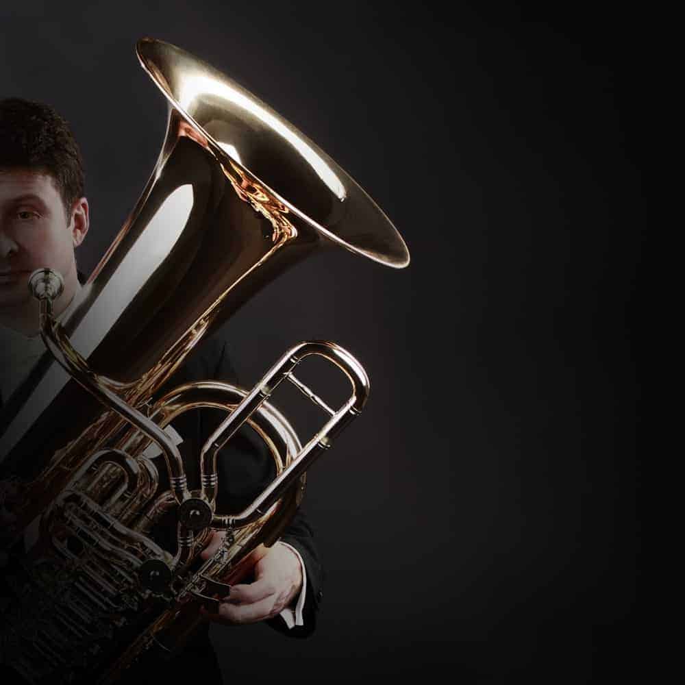 Musician holding a bass tuba.