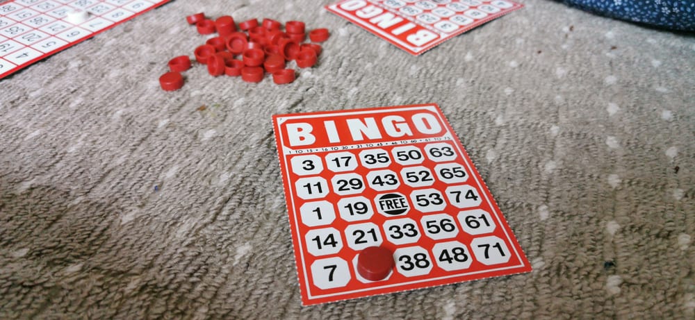 Red bingo cards over a carpet.