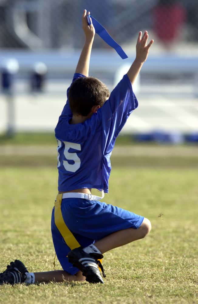 Boy in blue jersey playing capture the flag.