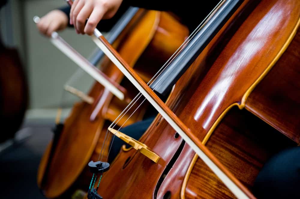 Closeup of the cello bows while a band plays cello.