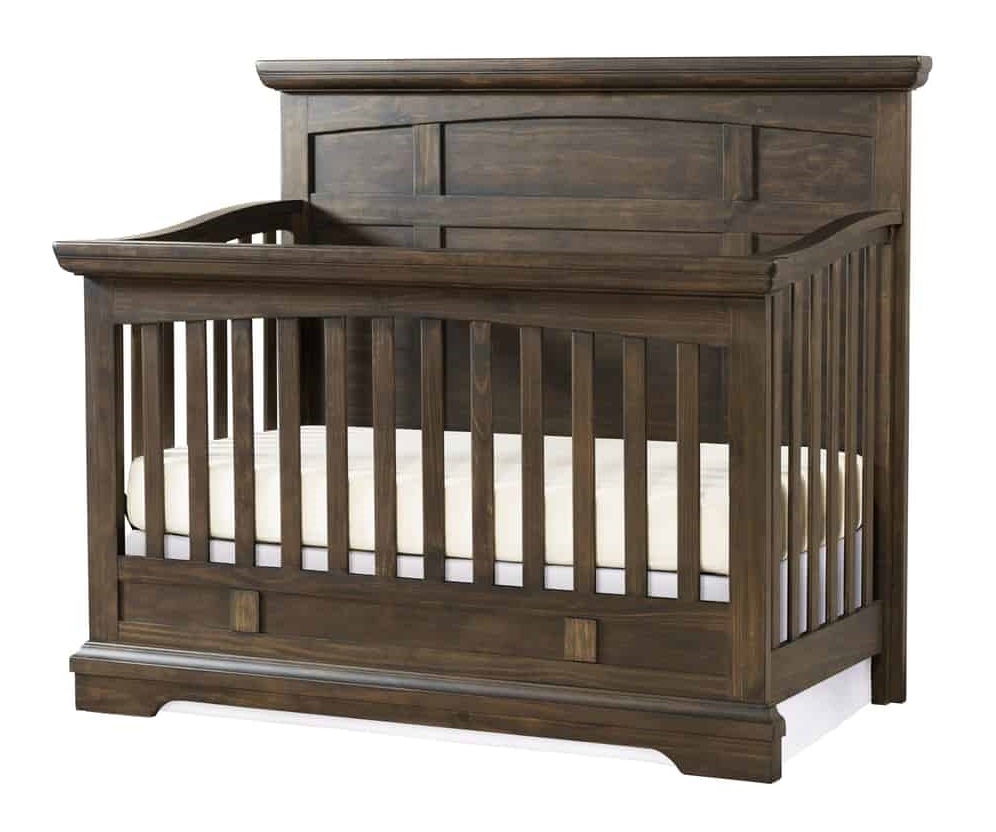 Convertible crib made in dark wood.
