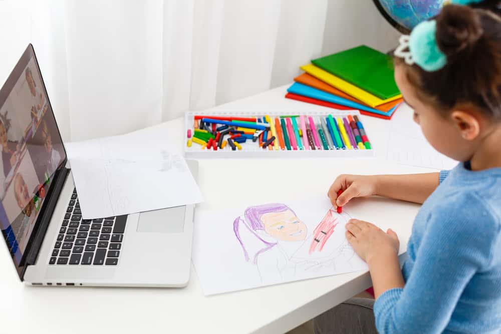 22 Best Drawing Toys for Kids Who Like to Draw 8 Little girl doing an activity during her online class.