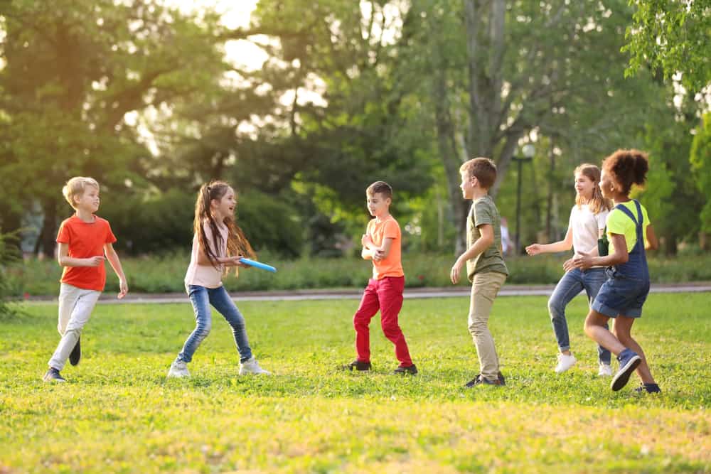 Children playing frisbee outdoors.