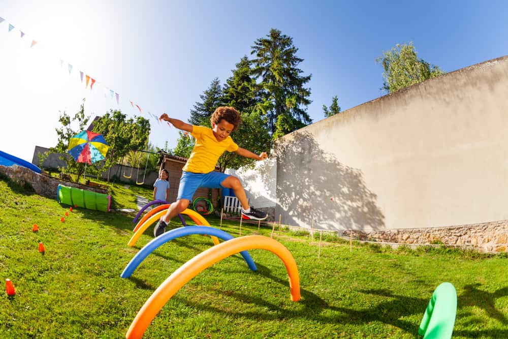 Boy jumping over obstacles.