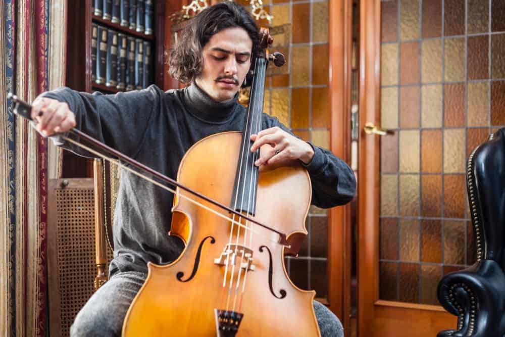 A man plays a cello made of poplar.