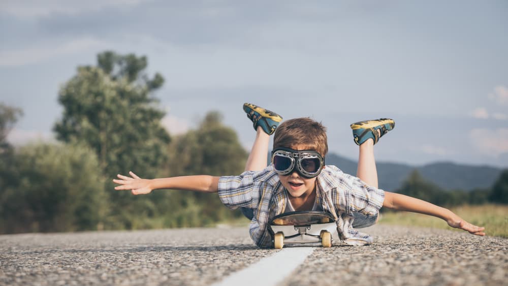 Boy riding a skateboard on the road.