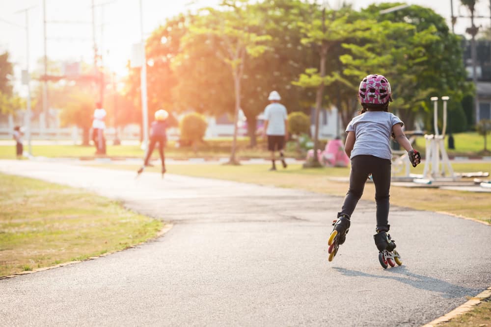 Kids roller skate in the park.